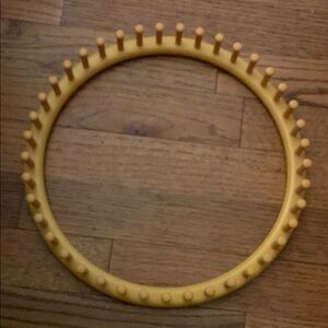 Yellow Circular Accessory with Smooth Texture and Gear-like Design